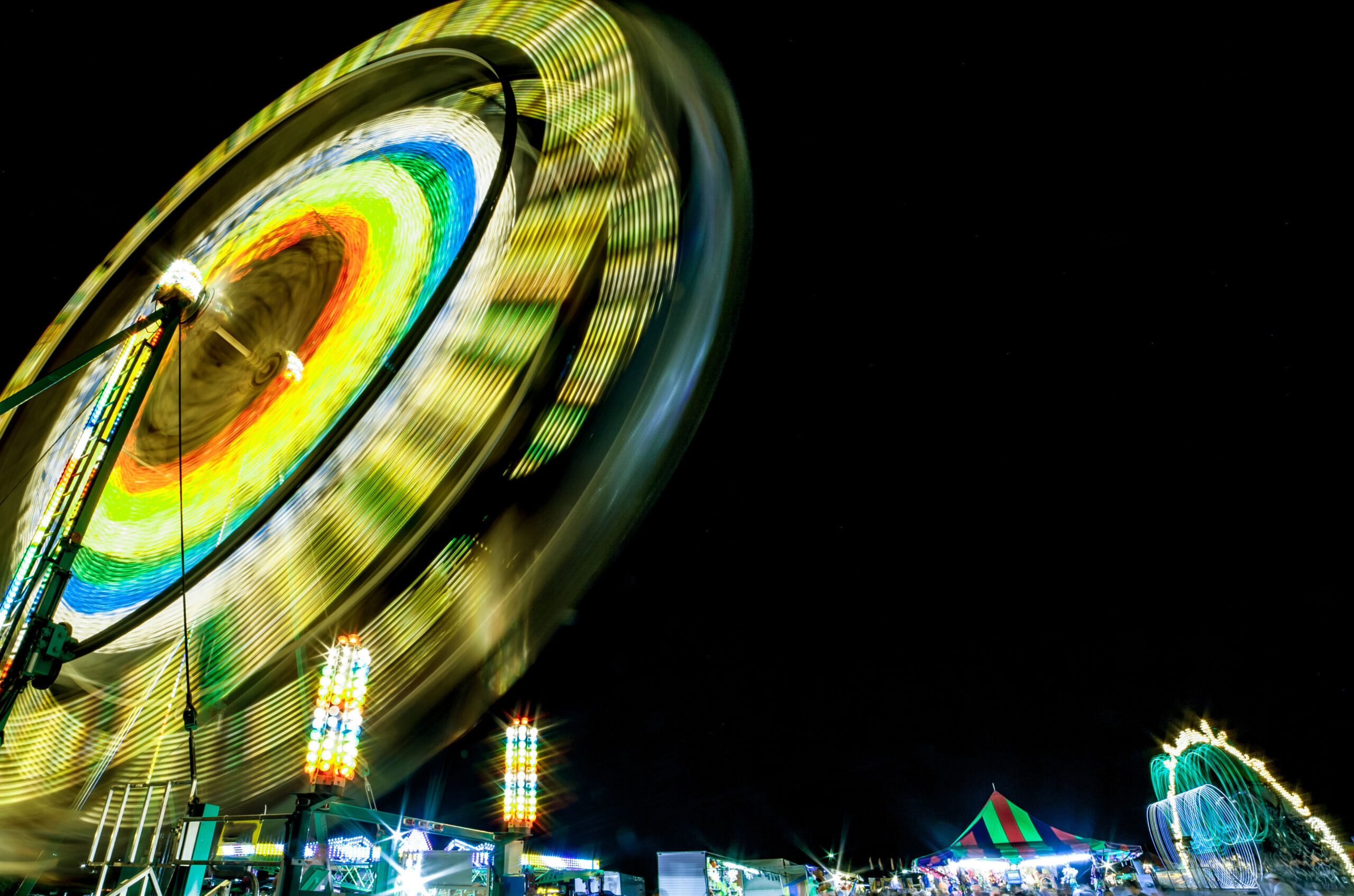 Neon lights on a ferris wheel at a carnival